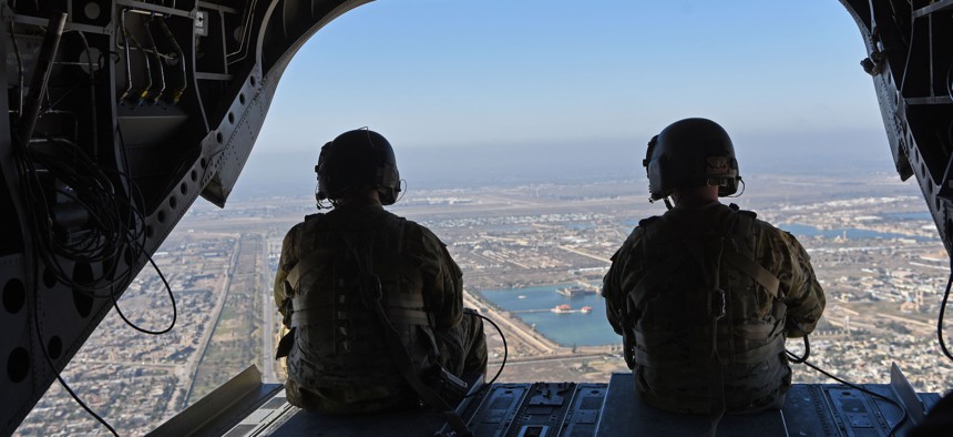 U.S. troops conduct aerial observations during a Chinook helicopter flight over Baghdad, Feb. 12, 2019.