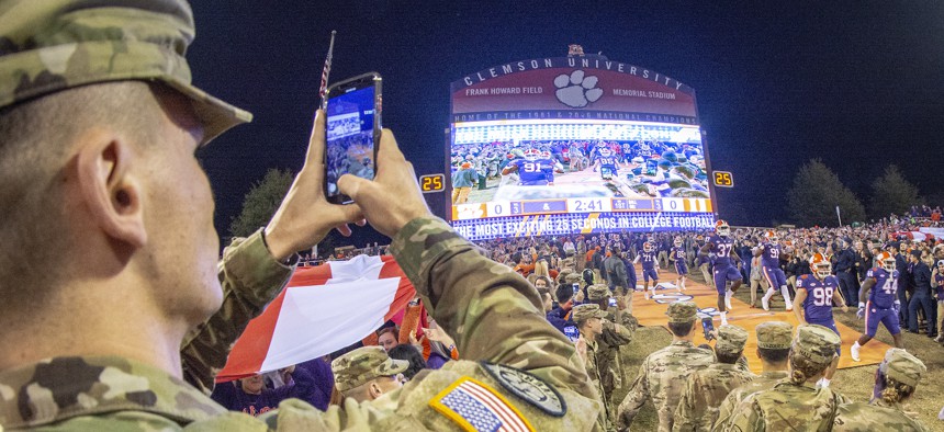 An Army ROTC cadet records the Clemson Tigers as they run down "The Hill" into Memorial Stadium to take on the Duke Blue Devils in their 2018 Military Appreciation Game, Nov. 17, 2018. The Tigers won 35 - 6