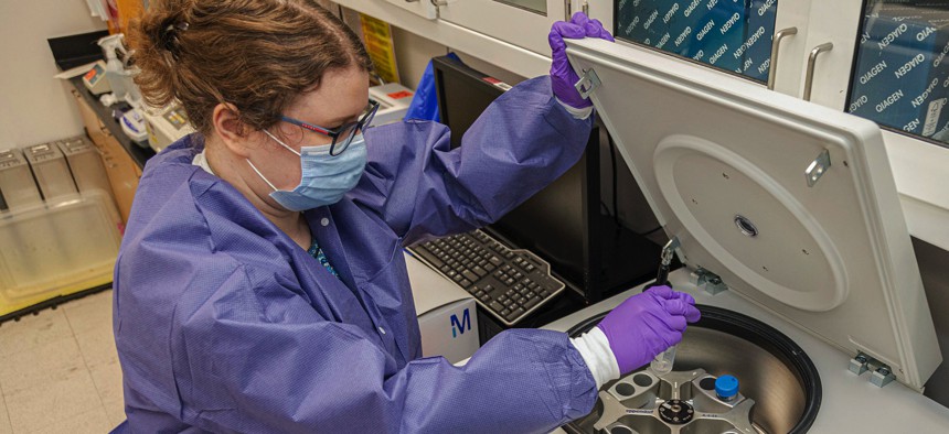 A scientist with the Emerging Infectious Disease branch of the Walter Reed Army Institute of Research conducts studies to find a vaccine for COVID-19 in July 2020.