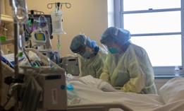 Two nurses assess the vital signs of a COVID-19 patient using a ventilator on the Intensive Care Unit floor at the Veterans Affairs Medical Center on April 21, 2020 in the Brooklyn borough of New York City. 