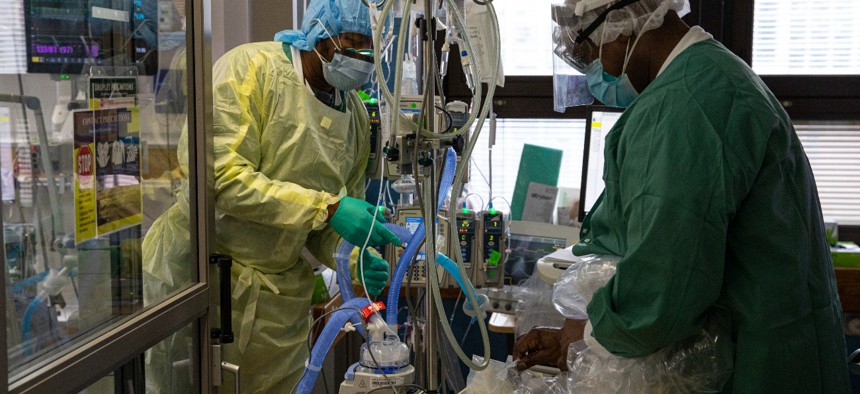 Two respiratory nurses prepare a portable respiratory device before treating a COVID-19 patient on the Medical Intensive Care Unit floor at the Veterans Affairs Medical Center April 24, 2020 in the Manhattan borough of New York City. 