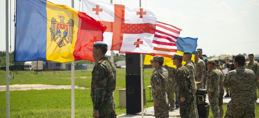 Romanian, Georgian, U.S. and Ukrainian flags are lowered signaling the end of Exercise Sea Breeze 2021 in Oleshky Sands, Ukraine, July 10, 2021.
