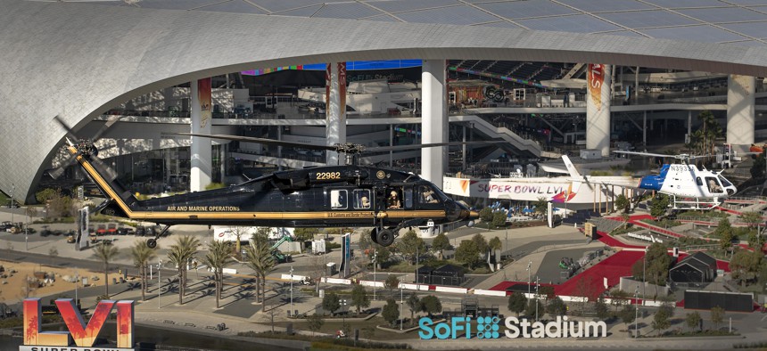 A U.S. Customs and Border Protection, Air and Marine Operations UH-60 Black Hawk and an AS350 A-Star passes by SoFi Stadium in Inglewood, California on Feb. 6.