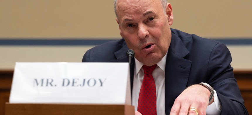 Postmaster General Louis DeJoy testifies on Capitol Hill last winter. DeJoy says the process of procuring new vehicles needs to keep moving forward. 