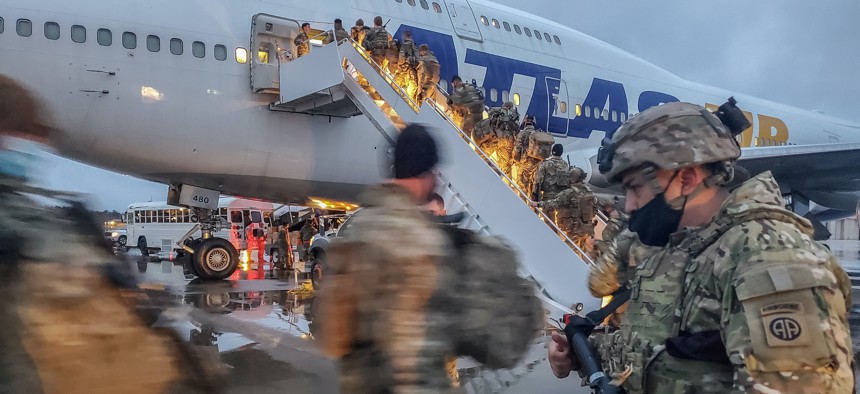 Paratroopers from the 82nd Airborne Division prepare to board a flight out of Fort Bragg, North Carolina, Feb. 7, 2022.