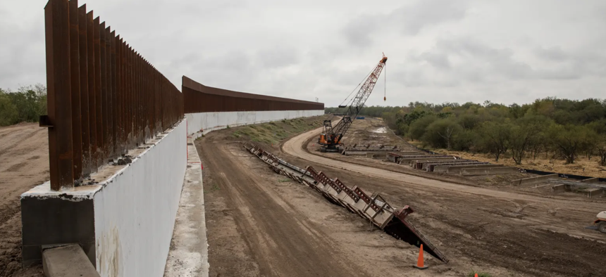 Construction on what the federal government says is a levee improvement project near Bentsen-Rio Grande Valley State Park in Mission on Jan. 12, 2022. Local immigrant advocates and environmentalists say the project is actually a border wall.