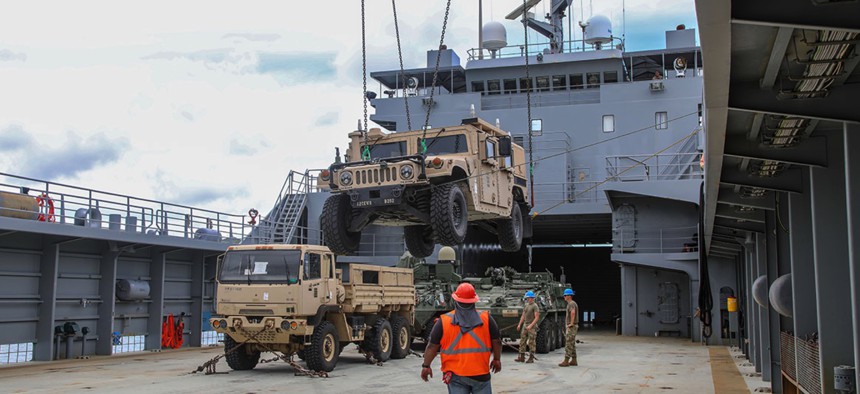 The crew of U.S. Army Vessel Lt. General William B. Bunker (LSV-4) loads equipment and supplies on LSV-4 in Guam in July 2021.