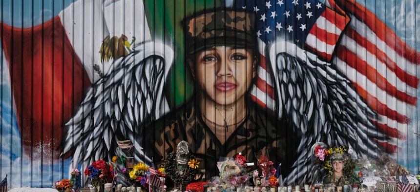Flowers and candles are left at a mural for murdered U.S. Army Private First Class Vanessa Guillen near Cesar Chavez High School in Houston, Texas in August 2020. 