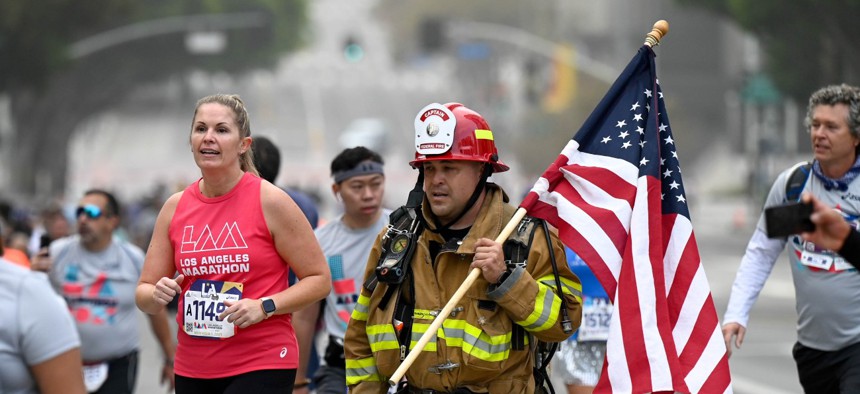 Federal firefighter Rudy Maron of Ventura ran wearing his turnout during the 36th LA Marathon on Nov. 7, 2021.