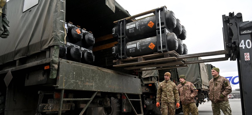 Ukrainian servicemen load a truck with the FGM-148 Javelin, American man-portable anti-tank missile provided by US to Ukraine as part of a military support, upon its delivery at Kyiv's airport Boryspil on February 11, 2022.