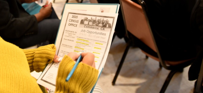 A job seeker takes notes during a 2020 Census recruiting event in California on Jan. 8, 2020.