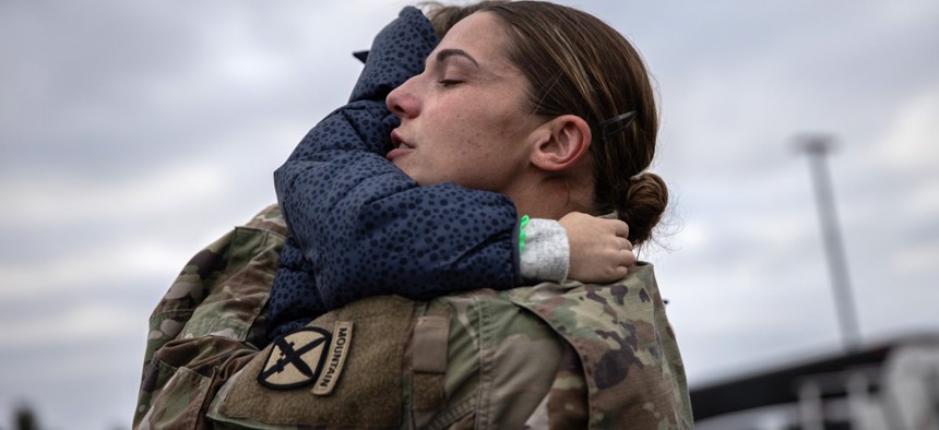 A family is reunited after a 9-month deployment to Afghanistan in December 2020 at Fort Drum, New York.