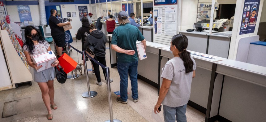 People wait in line at the Van Nuys, Calif. Post Office, Nov 30, 2021.