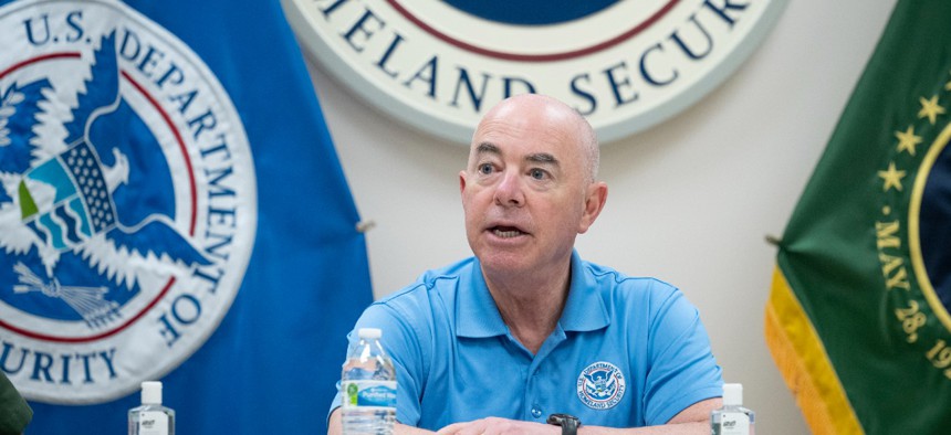 Homeland Security Secretary Alejandro Mayorkas participates in a roundtable meeting with local law enforcement officials at the McAllen Border Patrol Station in McAllen, Texas on May 17, with the DHS seal in the background. 