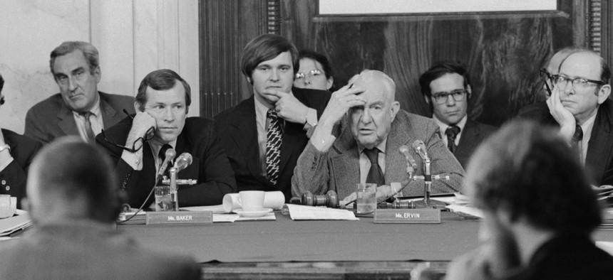Chairman of the Senate Watergate Committee Sam Ervin sits with Chief Counsel Sam Dash, Sen. Howard Baker, staffer Rufus Edmiston and others as they listen to a witness during the Watergate hearings.