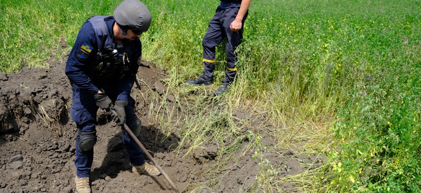 Ukrainian soldiers carry out demining works, remove shells and unexploded rockets in Kharkiv, Ukraine on June 9, 2022.
