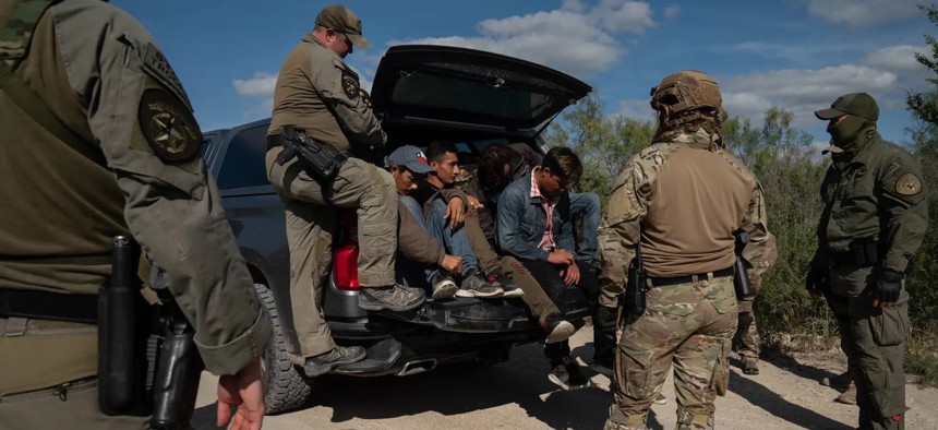 Texas Department of Public Safety special agents apprehend a group of five men from Honduras who were caught on private property as part of Operation Lone Star in Kinney County near Brackettville in November 2021.