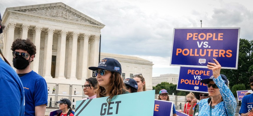 Environmental activists rally in front of the Supreme Court on July 6. The West Virginia v. EPA decision will have implications governmentwide, experts said. 