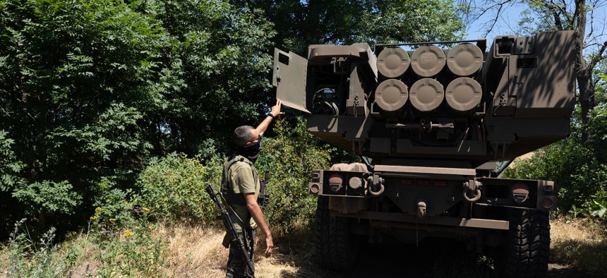A Ukrainian commander shows the rockets on a HIMARS vehicle in Eastern Ukraine, July 1, 2022. 