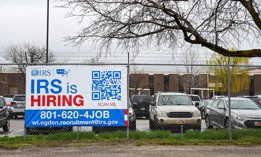 A sign seeking new new employees hangs outside at the Internal Revenue Service's facility in Ogden, Utah in March.