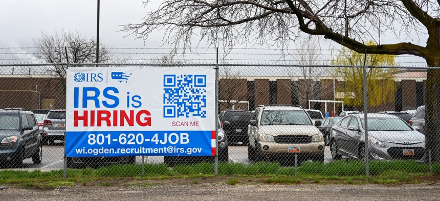 A sign seeking new new employees hangs outside at the Internal Revenue Service's facility in Ogden, Utah in March.