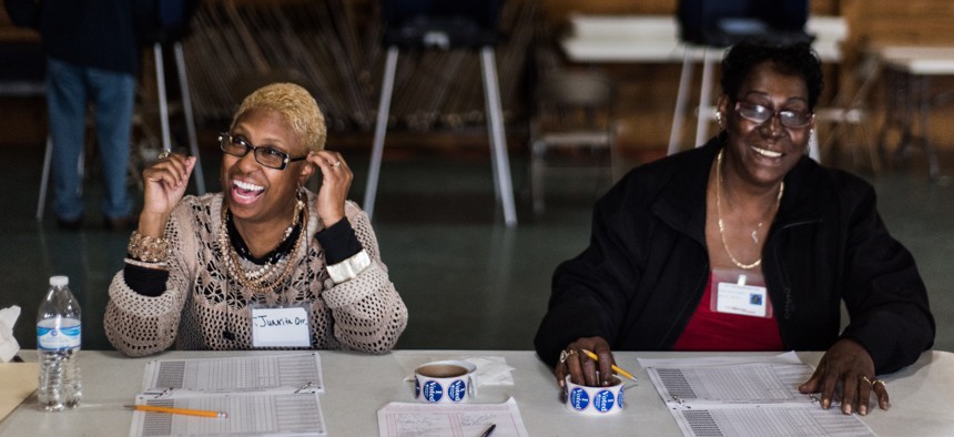  Poll workers share a laugh with voters in Cayce, South Carolina in 2016.