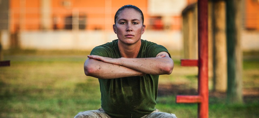 An officer candidate executes a squat during a physical training event at Officer Candidates School aboard Marine Corps Base Quantico, Virginia, July 30, 2019.