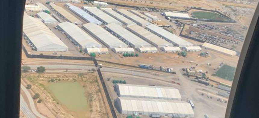 A bird’s-eye view of the Fort Bliss emergency intake shelter for unaccompanied migrant children in September 2021 shows rows of white, warehouse-size soft-sided tents.