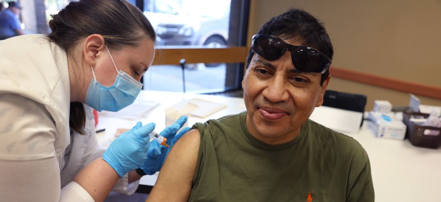 Gustavo Perez gets an influenza vaccine from pharmacist Patricia Pernal during an event hosted by the Chicago Department of Public Health at the Southwest Senior Center on September 09, 2022 in Chicago, Illinois.