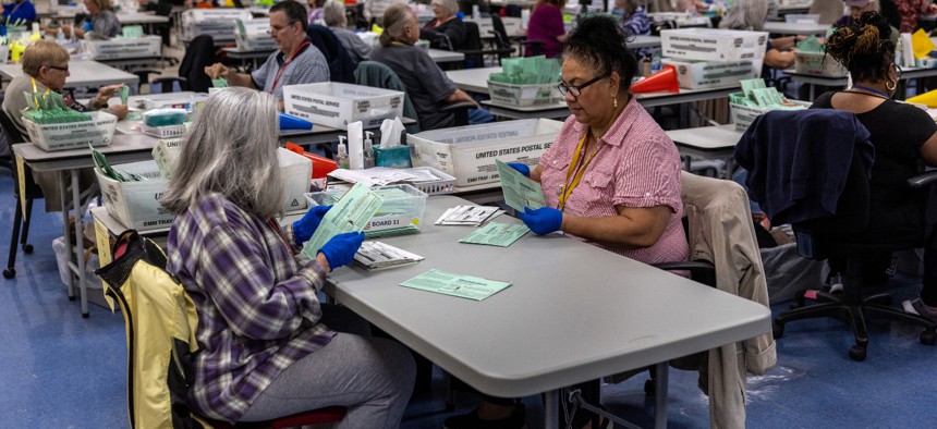 Election workers sort ballots at the Maricopa County Tabulation and Election Center on November 9 in Phoenix, Arizona. 