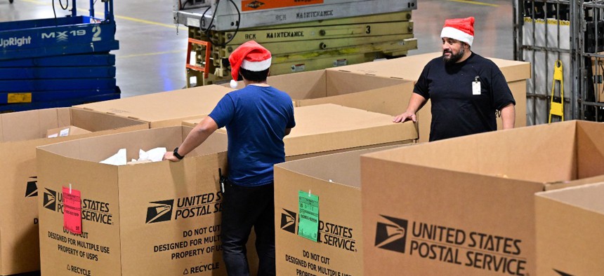 U.S. Postal Service employees  sort mail at the Los Angeles Processing and Distribution Center in preparation for another busy holiday season on November 30.