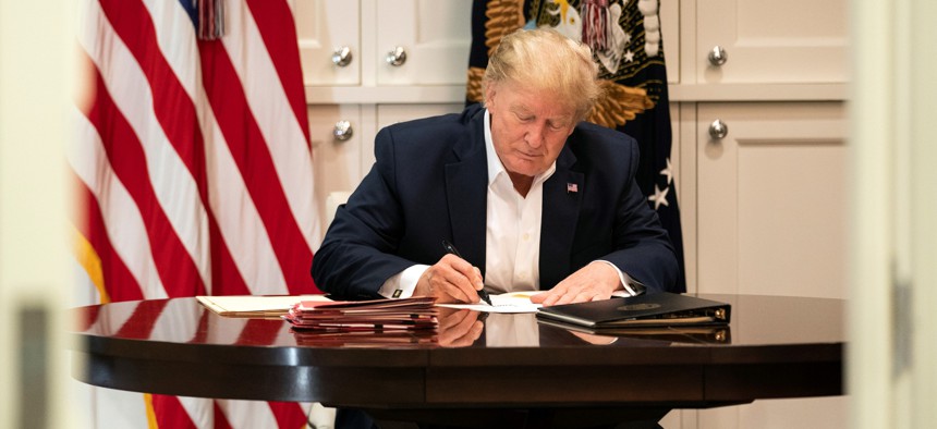 Then-President Trump shown here on Oct. 3, 2020 after testing positive for COVID-19. That same month Trump signed an executive order establishing a new Schedule F within the federal government’s excepted service for federal workers in policy-related jobs and exempting their positions from most civil service rules.