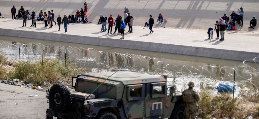 Texas National Guard and Texas Department of Public Safety officers position themselves on the banks of the Rio Grande in El Paso on Dec. 20. The U.S. Supreme Court on Tuesday ruled to keep in place Title 42 for now