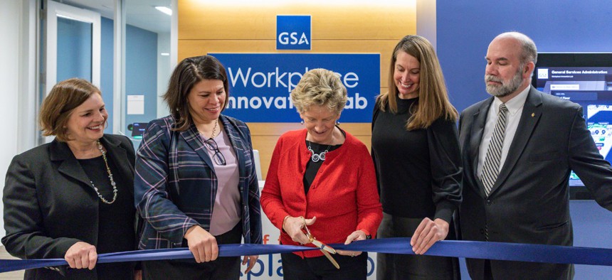 From left, Lisle Hannah, director of the Office of Facilities and Environmental Quality at the Commerce Department; Nina Albert, commissioner of the Public Buildings Service; Robin Carnahan, GSA administrator; Katy Kale, deputy administrator of GSA; and Chuck Hardy, GSA chief architect, take part in a ribbon cutting ceremony for the new space. 