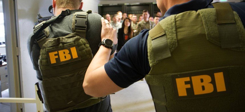 Federal Bureau of Investigation team members demonstrate an execution of a search warrant in a potential hostile environment during the exercise portion of Cyber Shield 19 at Camp Atterbury, Ind., April 17, 2019.