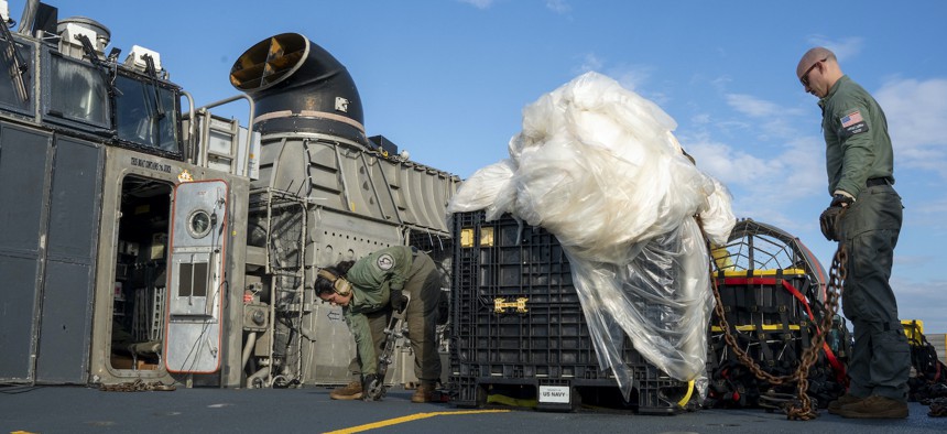 Sailors assigned to Assault Craft Unit 4 prepare material recovered in the Atlantic Ocean from a high-altitude balloon for transport to federal agents at Joint Expeditionary Base Little Creek Feb. 10, 2023.