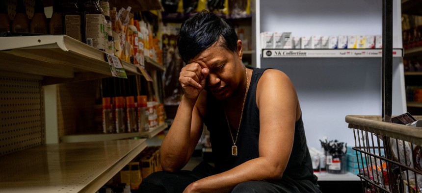 Business owner Lynn Gooden takes a pause a she works at her store, Mother's Hair Beauty Supply in Houston.