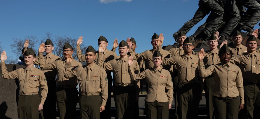 U.S. Marines with 2nd Marine Logistics Group, reenlist into the Marine Corps at the Marine Corps War Memorial in Arlington, Va. on Feb. 23, 2023. 