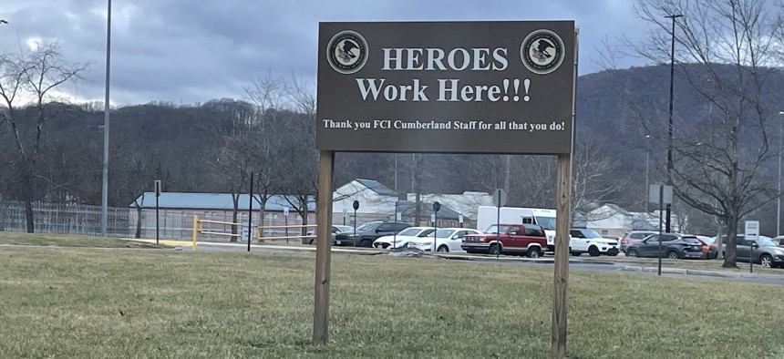 This sign greets visitors on the drive leading up to the federal correctional institution facility in Cumberland, Md. Staffing shortages have added to the stress of correctional officers across the federal prisons system, including those here. The bureau’s new director, Colette Peters, is trying to address this and other longstanding issues at the agency. 