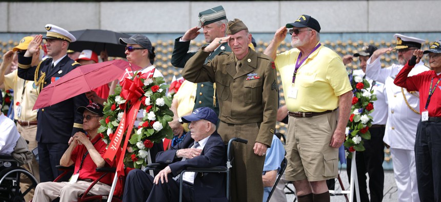 World War II veterans, their families and military representatives of the countries that participated in the D-Day invasion hold a wreath laying ceremony at the World War II Memorial on the National Mall on the 75th anniversary of Operation Overlord, June 06, 2019 in Washington, DC.
