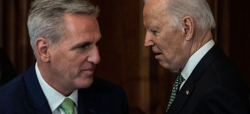 President Biden (right), walks past House Speaker Kevin McCarthy, R-Calif., after delivering remarks at the annual Friends of Ireland Caucus St. Patrick's Day Luncheon in the Rayburn Room of the U.S. Capitol on March 17. McCarthy said it is time for the two to roll up their sleeves and get to work on debt ceiling negotiations. 