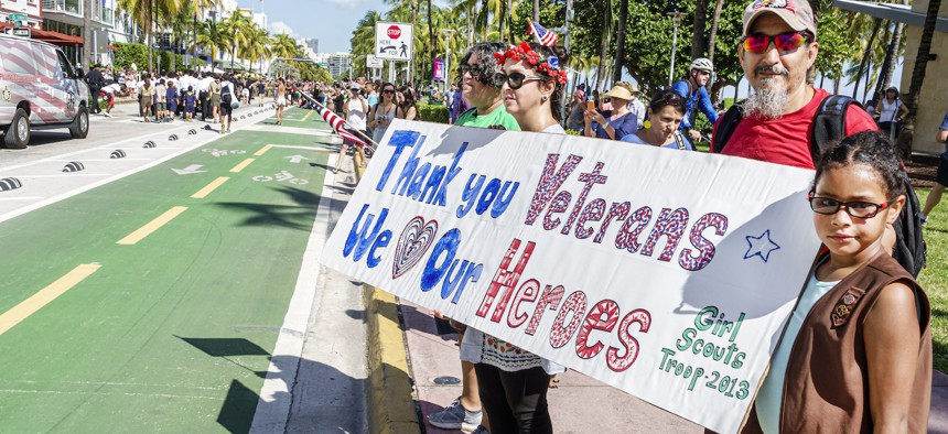 Spectators watch a Veterans Day parade in Miami in 2022.