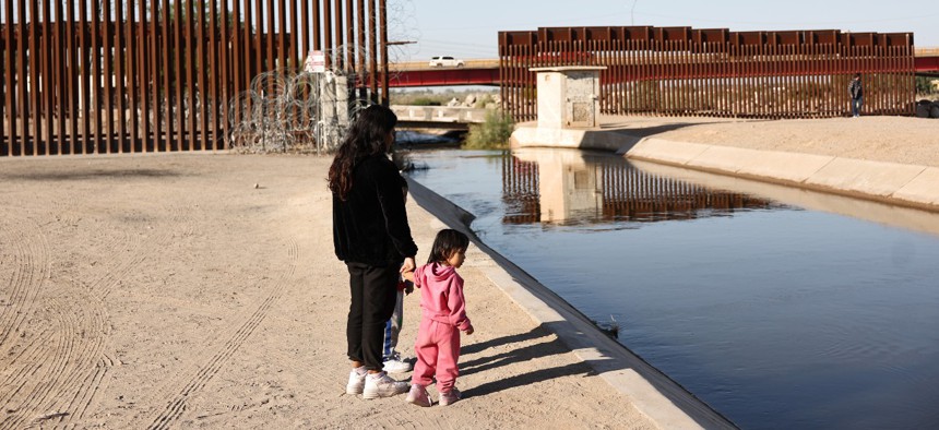 Peruvian mother Miriam walks with her daughter Dulce, 2, and son Valenti, 5, who are seeking asylum in the United States, as they wait to be processed by U.S. Border Patrol agents after crossing into Arizona from Mexico on May 12, 2023 in Yuma, Arizona. A court ruling late Thursday could contribute to dangerous, crowded conditions at the border, Biden administration officials said. 