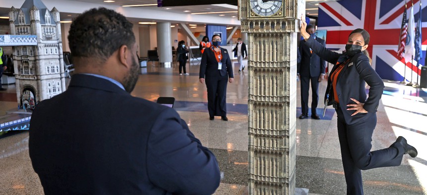 A JetBlue employee poses next to a Boston replica of London’s Big Ben before the launch of nonstop flights between Boston and London in 2022.