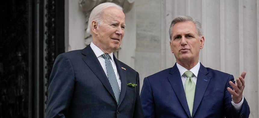 President Biden and Speaker of the House Kevin McCarthy talk as they depart the U.S. Capitol in March. Biden and McCarthy compromised to avoid a debt default. 