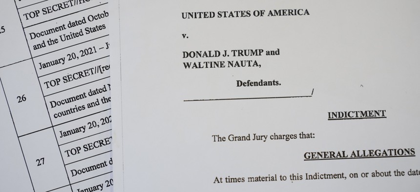 This photo illustration shows pages from the unsealed federal indictment of former President Donald Trump on June 9, 2023. Trump has been indicted on 37 felony counts in Special Counsel Jack Smith's classified documents probe. 