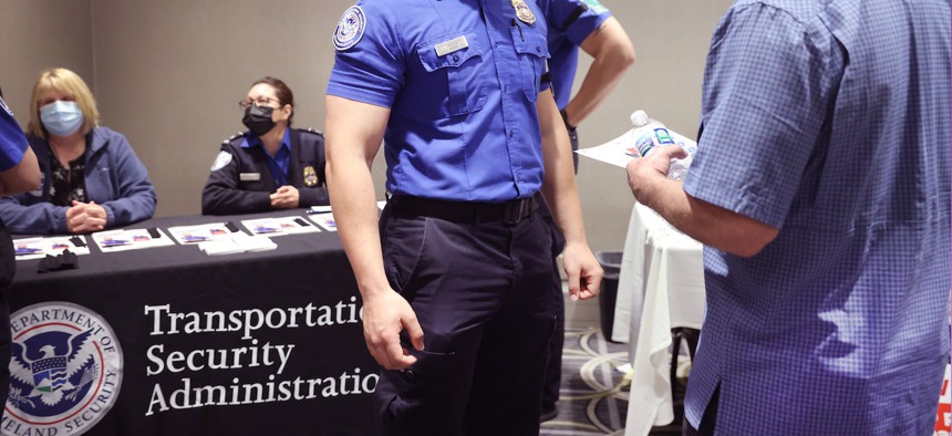 Recruiters with the Transportation Security Administration speak with job seekers during a job fair O’Hare International Airport in Chicago on May 19, 2021. Nearly $400 million was included in the fiscal 2023 omnibus spending package for TSA pay raises.