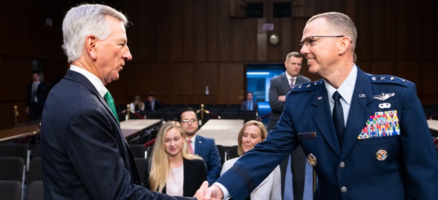 Sen. Tommy Tuberville, R-Ala., shakes hands with Air Force Lt. Gen. Gregory M. Guillot before the start of the Senate Armed Services Committee confirmation hearing on the nominations of Lt. Gen. Gregory M. Guillot, nominee to be general and commander of the U.S. Northern Command and commander of the North American Aerospace Defense Command, and Lt. Gen. Stephen N. Whiting to be general and commander of the U.S. Space Command on Wednesday, July 26, 2023.