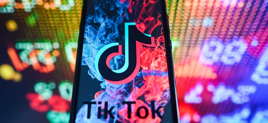 Industry groups are asking for more clarity and raising potential issues about an interim rule to ban TikTok on contractors' mobile devices. 