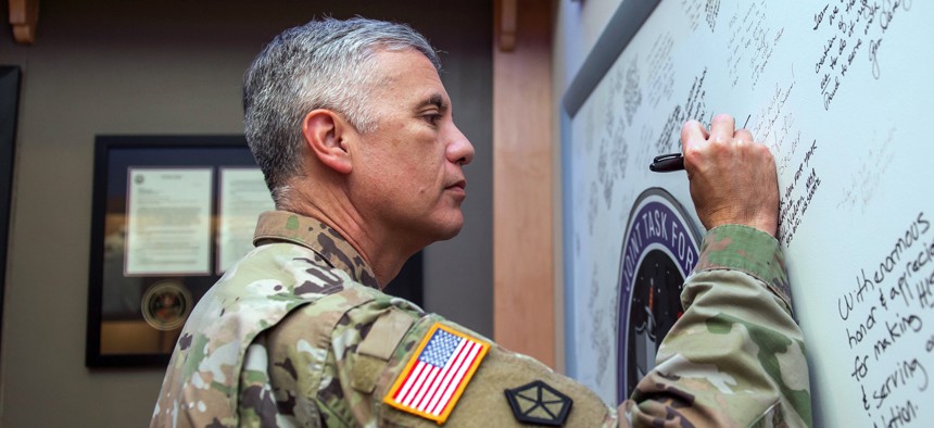 U.S. Army Gen. Paul M. Nakasone, commander of U.S. Cyber Command and director of the National Security Agency, signs the Joint Task Force-Space Defense’s board during a visit to Schriever Space Force Base, Colorado, on July 26, 2022.